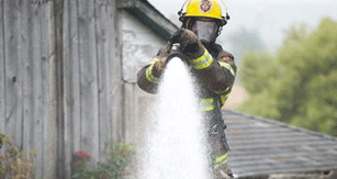 Firefighter spraying water