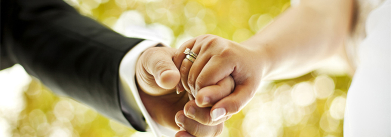 hands of bride and groom holding each other